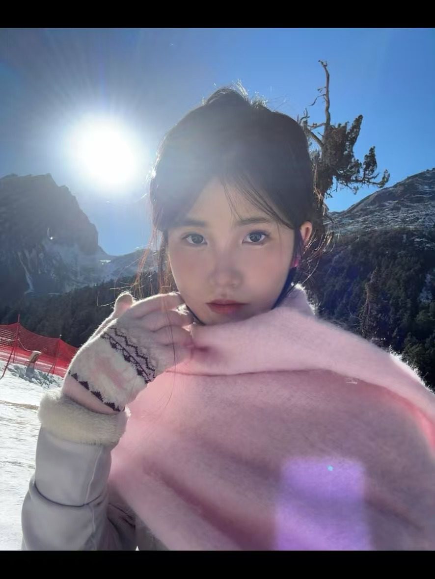雪山前围着粉色围巾的照片